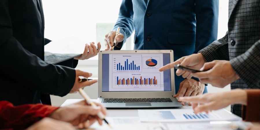 Protea Financial Types of Business Debt black notebook on a desk with payables written on the front with several pens next to it