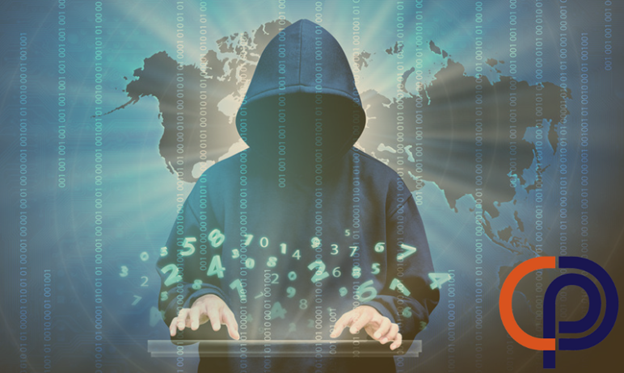 A cyber threat in a hoodie using a computer