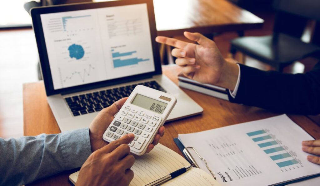 Protea Financial Wine Inventory Costing Strategies people discussing costs and using a calculator