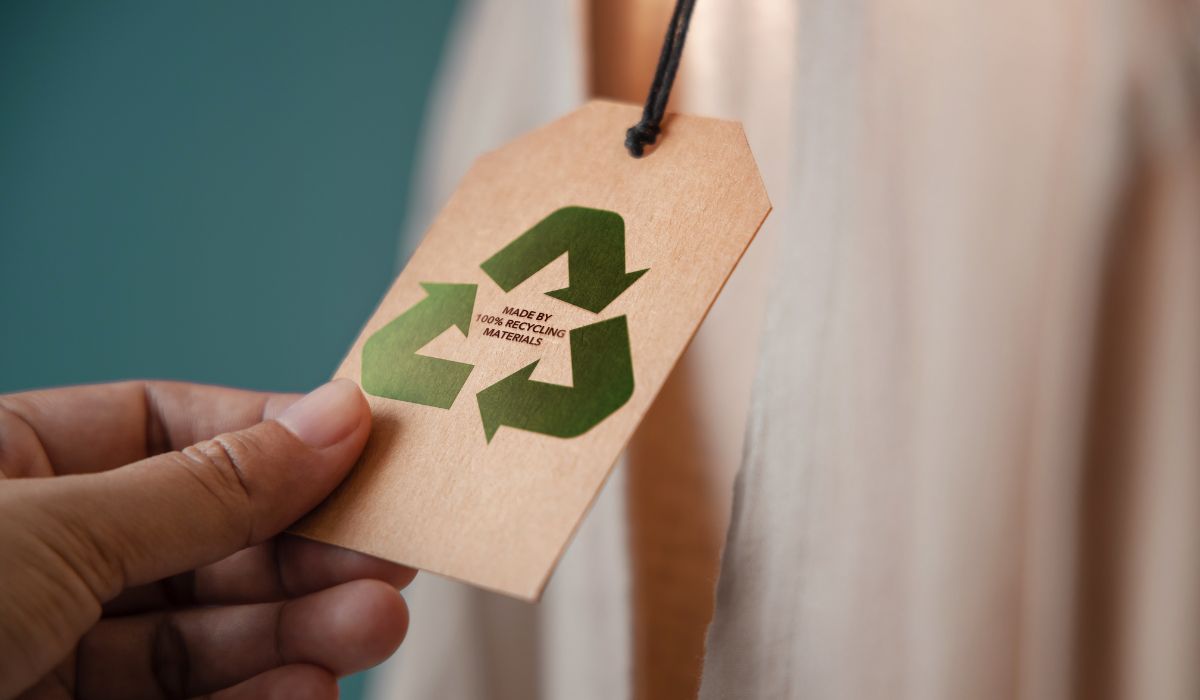 Protea Financial Recycling tag with someone holding a tag showing made of recycled materials