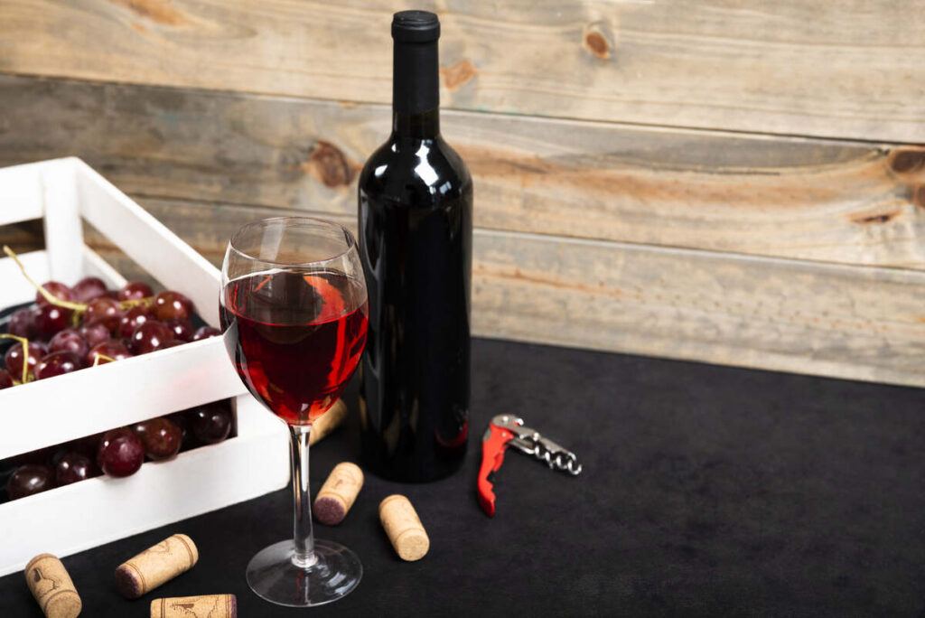 glass red wine with wooden background