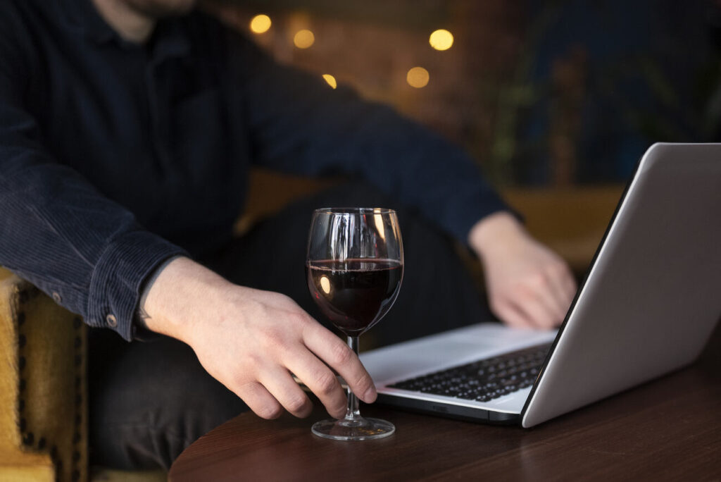 man coding on his laptop for a winery business