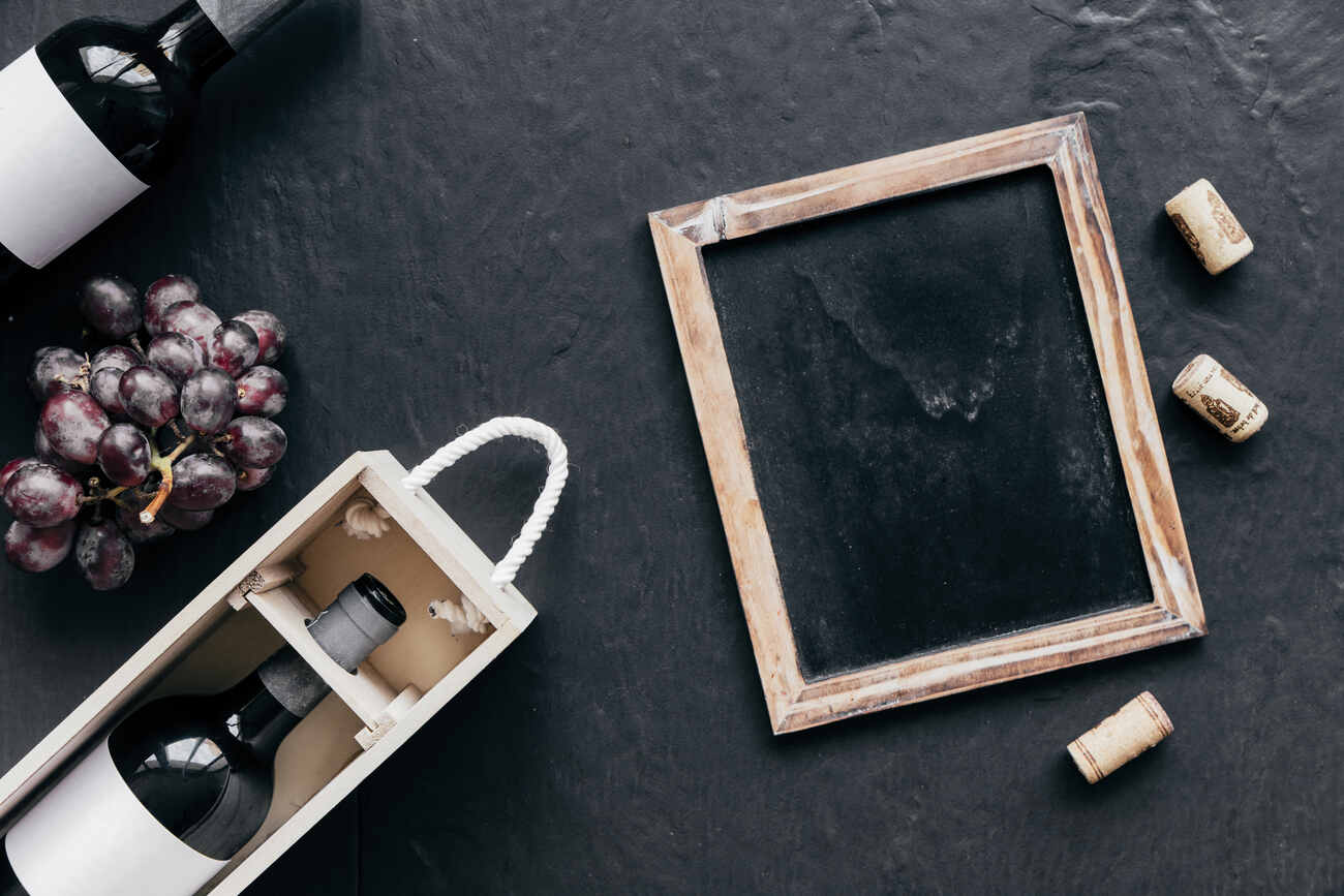 blackboard full of corks nea bottles and grape for wine accounting